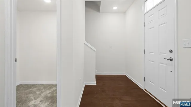 a kitchen with stainless steel appliances granite countertop a refrigerator a stove a sink and a microwave