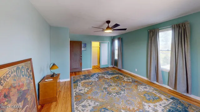 a bedroom with natural light and wooden floor