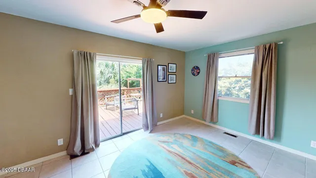 a view of a bedroom with a bed and a window