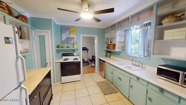 a large kitchen with stainless steel appliances granite countertop a stove and a sink