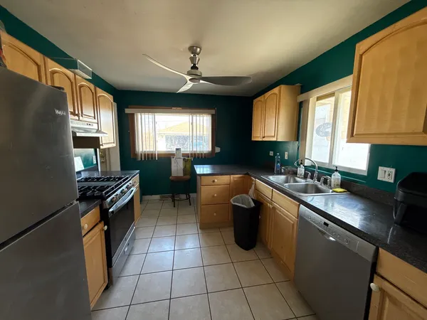 a kitchen with stainless steel appliances granite countertop a sink stove and cabinets