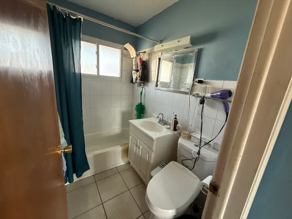 a white toilet sitting next to a bathroom sink