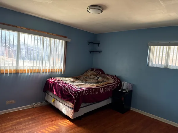 a bedroom with a bed and window