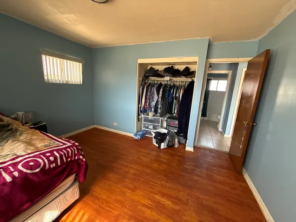 a bed room with a bed and a mirror