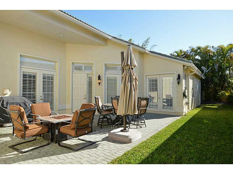 7070 Northwest Turtle Walk Boca Raton, FL 33487 - Photo 2 of 10 a building outdoor space with patio furniture