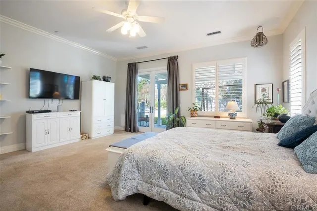 a bedroom with a bed and a lamp on dresser