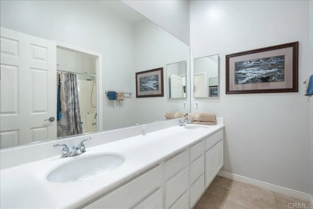 a view of a patio with couches and chairs under an umbrella