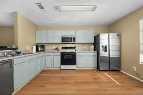 a kitchen with a refrigerator sink and microwave