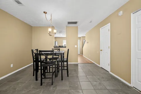 a dining room with furniture and window