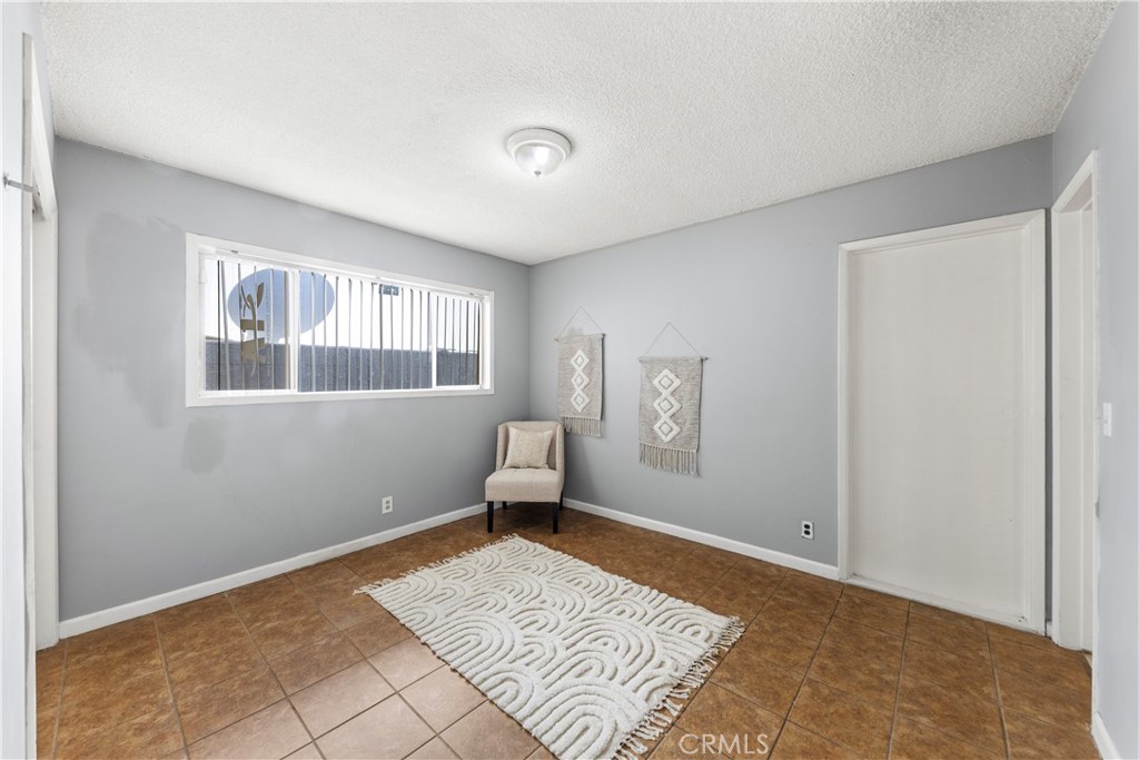 609 Elbrook Drive Fallbrook, CA 92028 - Photo 13 of 30 a bedroom with a bed and wooden floor