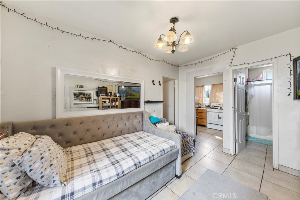 609 Elbrook Drive Fallbrook, CA 92028 - Photo 20 of 30 a bedroom with a large bed and a chandelier