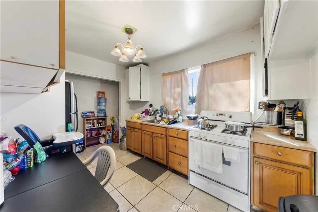 609 Elbrook Drive Fallbrook, CA 92028 - Photo 22 of 30 a kitchen that has a lot of cabinets in it and wooden floors