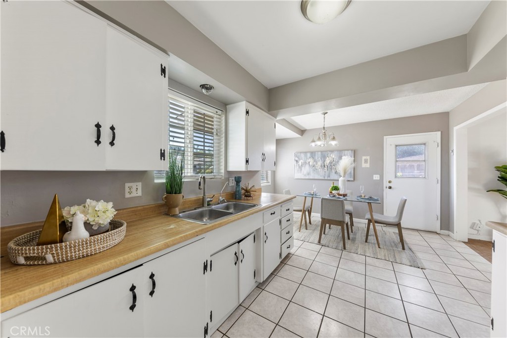 609 Elbrook Drive Fallbrook, CA 92028 - Photo 4 of 30 a kitchen with granite countertop lots of white cabinets and appliances