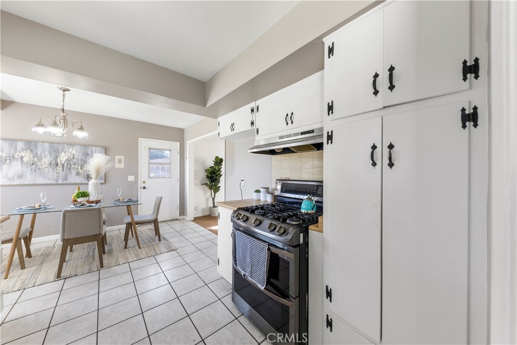 609 Elbrook Drive Fallbrook, CA 92028 - Photo 5 of 30 a kitchen with stainless steel appliances a stove a sink and a refrigerator