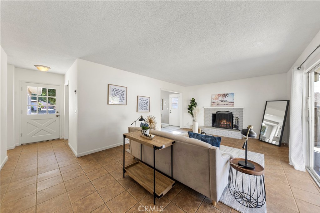 609 Elbrook Drive Fallbrook, CA 92028 - Photo 10 of 30 a living room with furniture a fireplace and a window