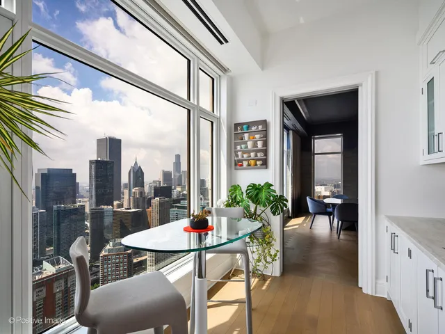 a dining room with furniture and a floor to ceiling window