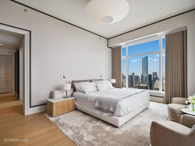 a bedroom with bed and a large mirror