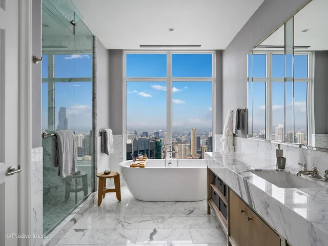 a large kitchen with kitchen island a large counter top space a sink stainless steel appliances and windows