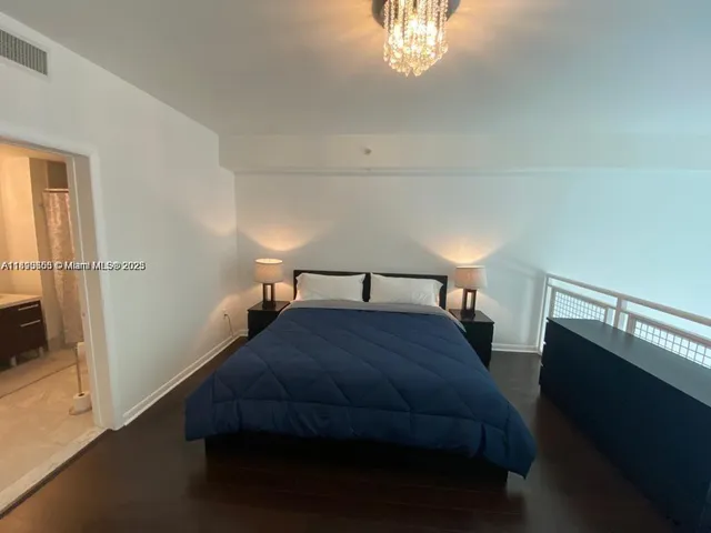 a bathroom with a sink a toilet a mirror a vanity and shower