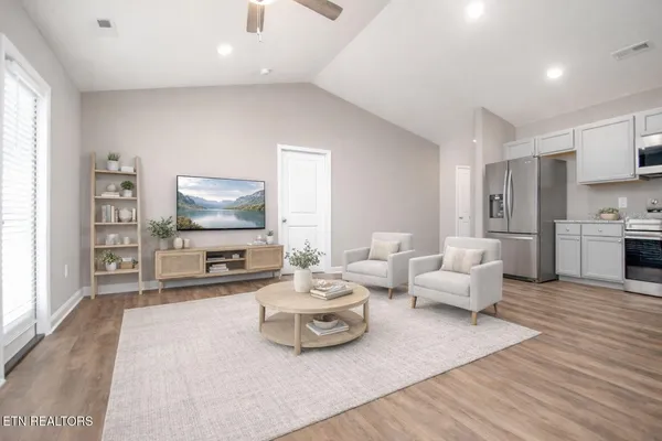 a living room with furniture and a flat screen tv