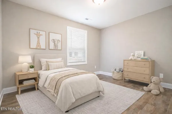 a bedroom with a bed and window