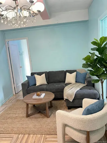 a living room with furniture and a potted plant