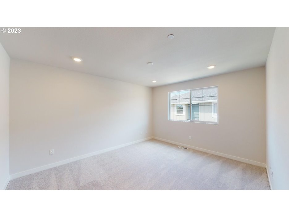 12915 Southwest Tabor Terrace Beaverton, OR 97007 - Photo 7 of 11 a open hall with a floor to ceiling window and a projector screen