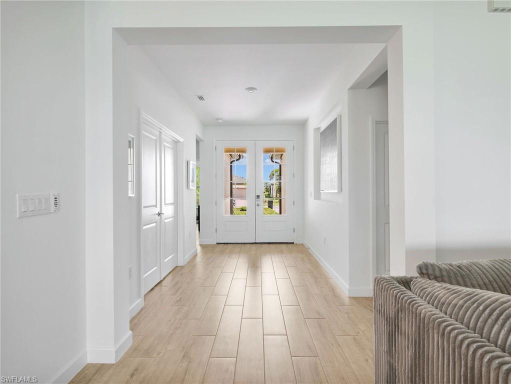 18278 Ridgeline Drive Estero, FL 33928 - Photo 4 of 45 a view of a hallway with wooden floor