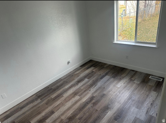 265 Mindella Way Layton, UT 84041 - Photo 18 of 32 Light-filled room featuring wood-finish flooring, white baseboards, and a double-pane window