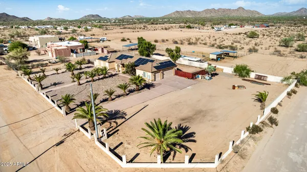 an aerial view of a house with a yard