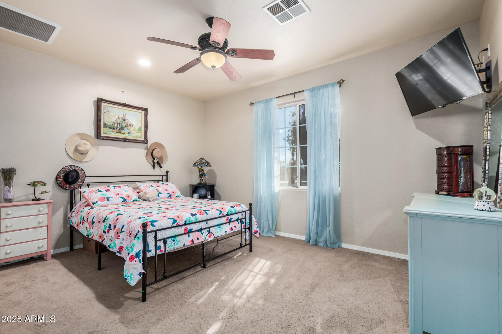 11381 Warrior Road Casa Grande, AZ 85193 - Photo 16 of 73 a bedroom with a bed and a chandelier