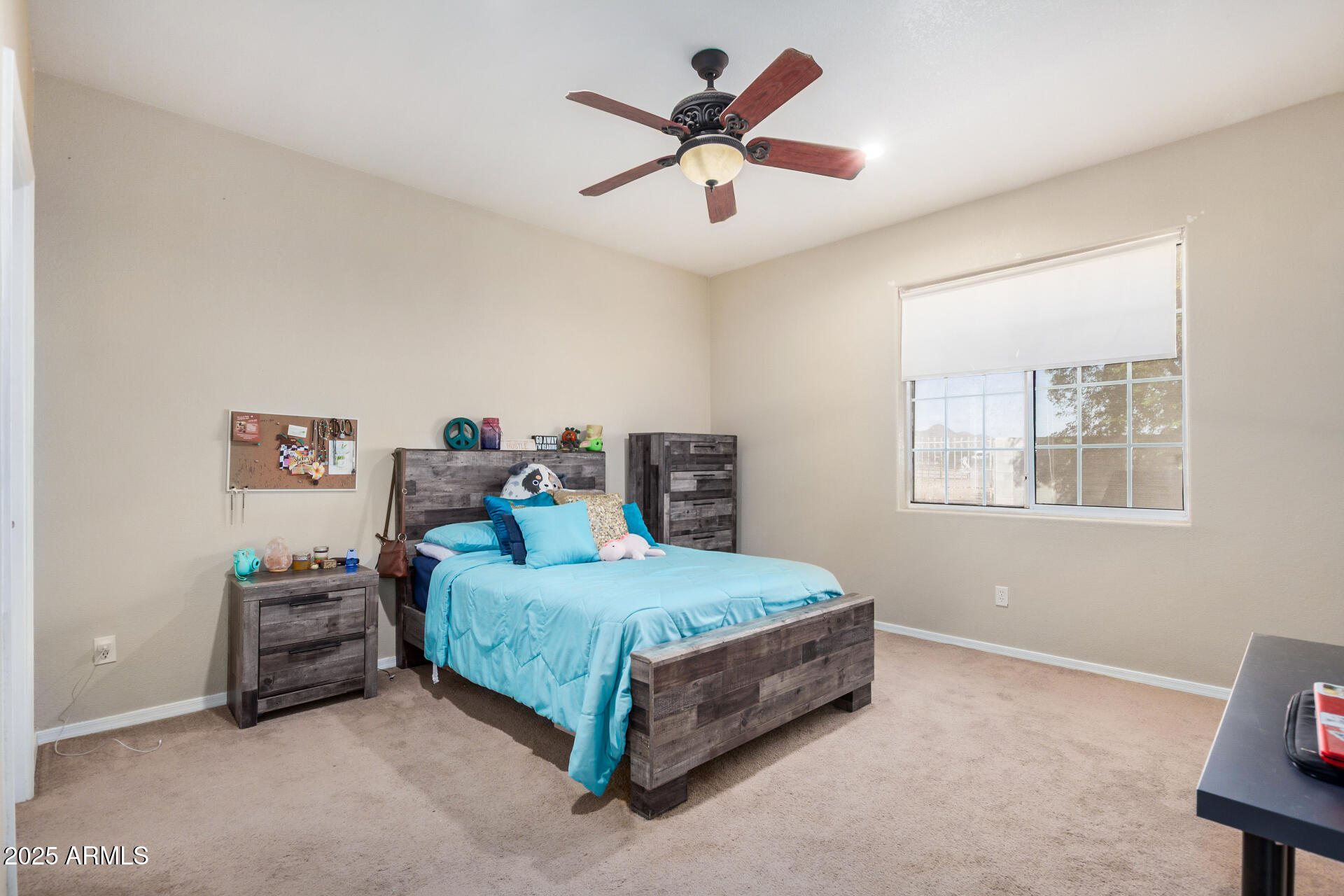 11381 Warrior Road Casa Grande, AZ 85193 - Photo 27 of 73 a bedroom with a bed a chandelier and a window