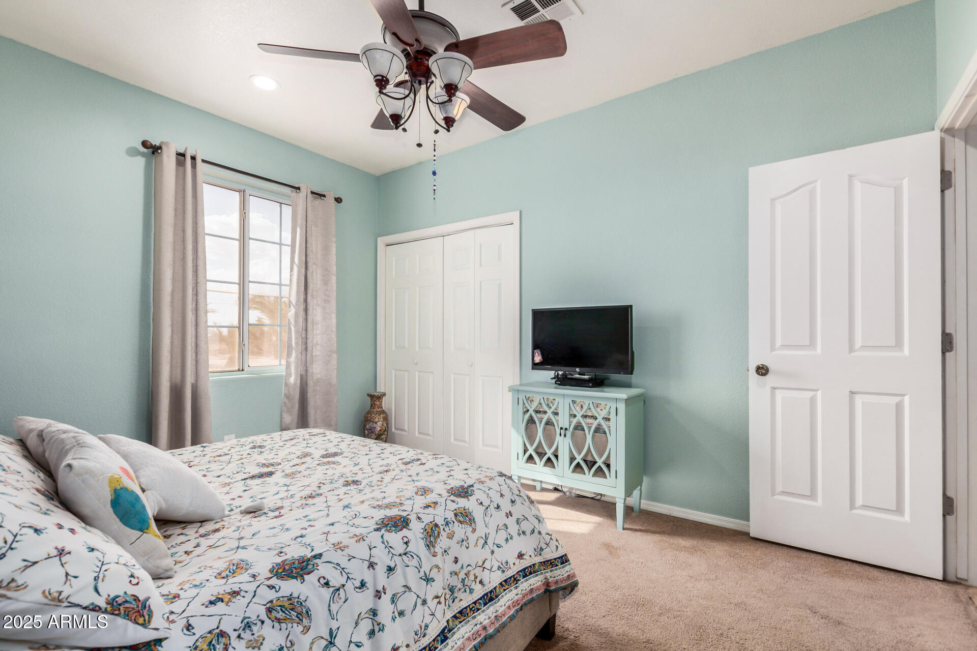 11381 Warrior Road Casa Grande, AZ 85193 - Photo 29 of 73 a bedroom with a bed and a flat tv screen on dresser