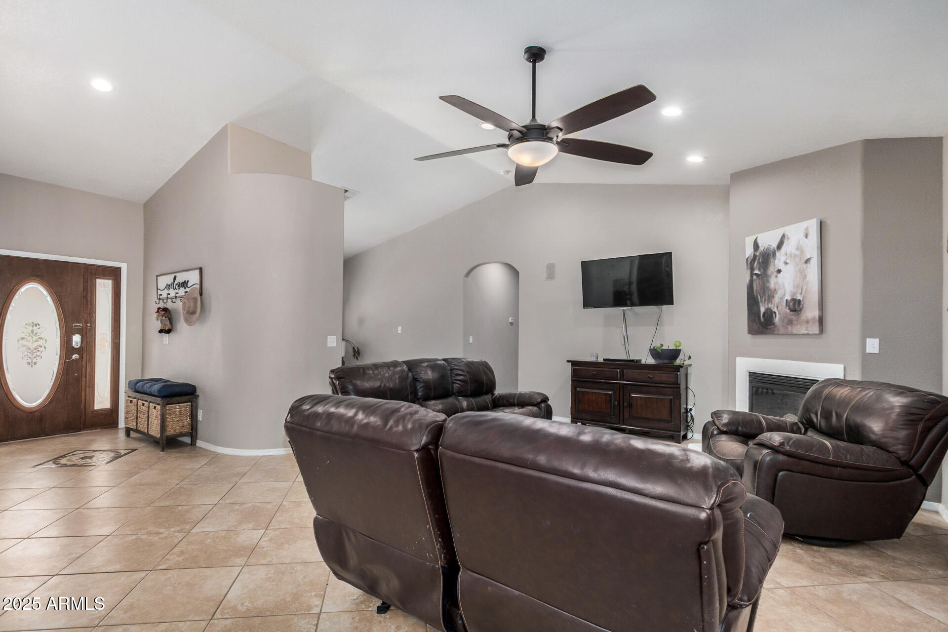 11381 Warrior Road Casa Grande, AZ 85193 - Photo 4 of 73 a living room with furniture a ceiling fan and a flat screen tv