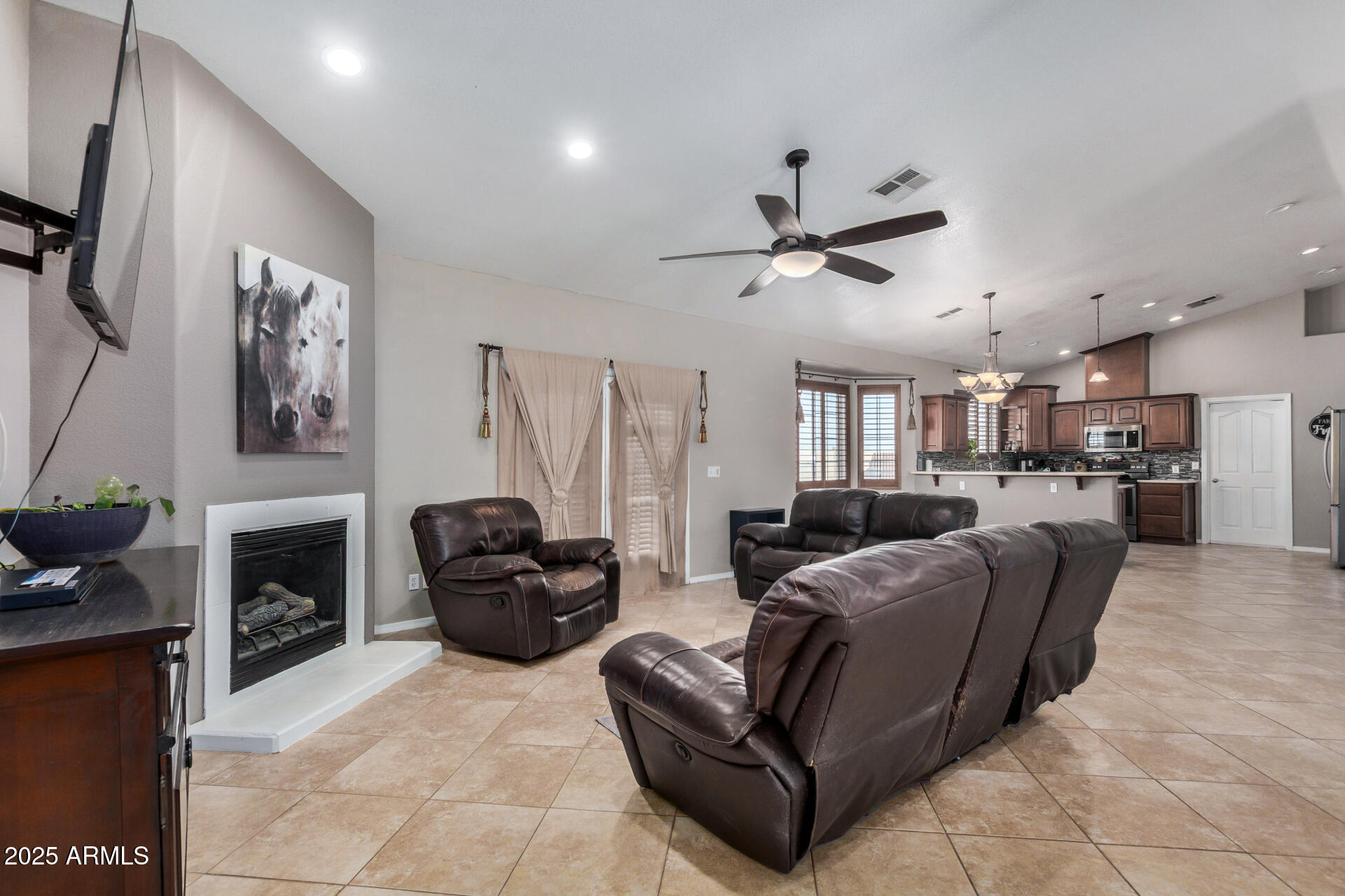 11381 Warrior Road Casa Grande, AZ 85193 - Photo 7 of 73 a living room with furniture a fireplace and a flat screen tv