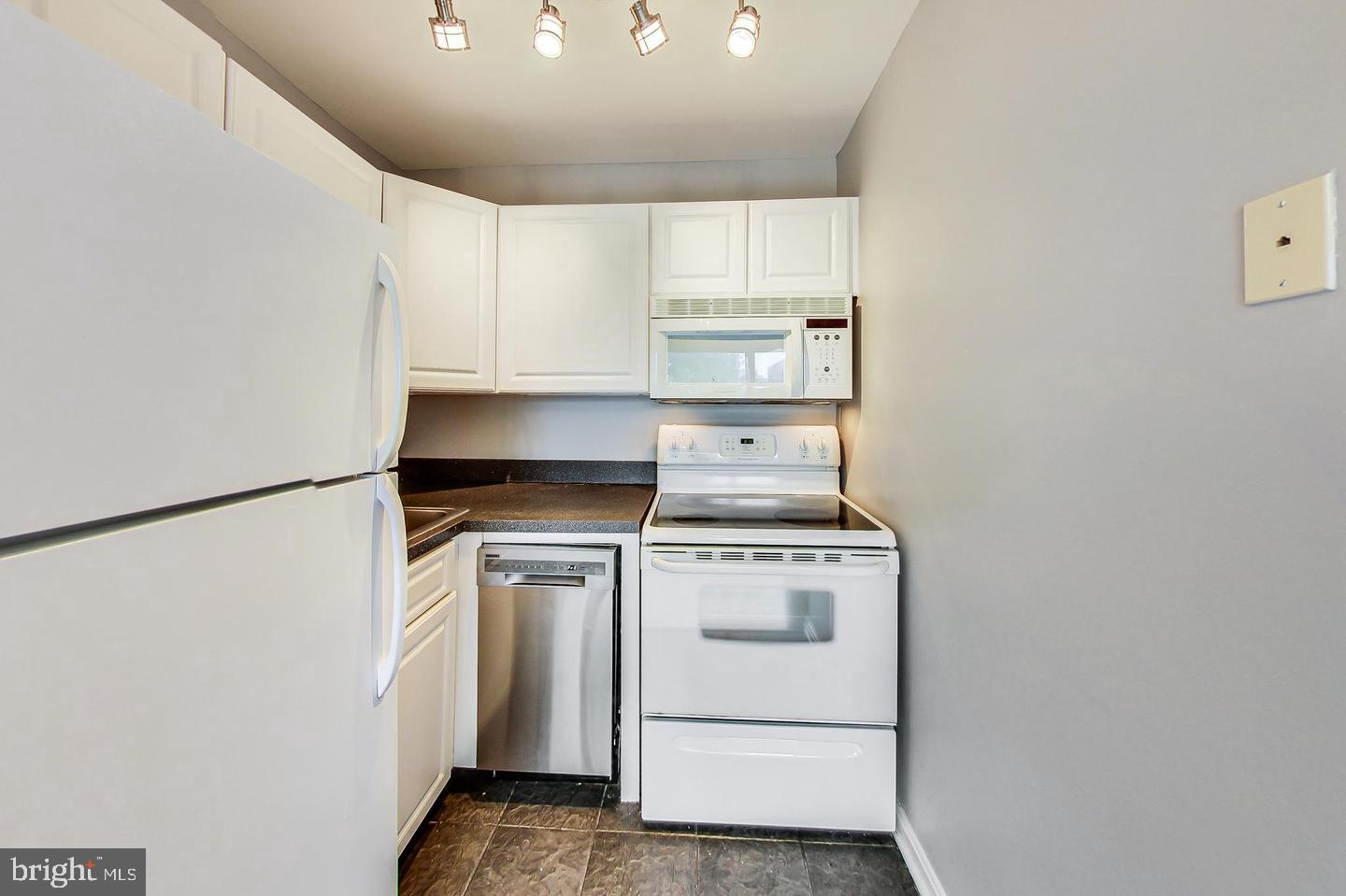 604 Longfellow Street Northwest, Unit 303 Washington, DC 20011 - Photo 8 of 12 a view of a kitchen with stove and refrigerator