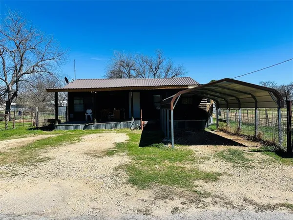 a view of a house with a yard and porch