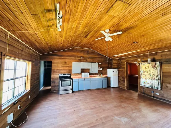 a view of a livingroom with furniture window and wooden floor