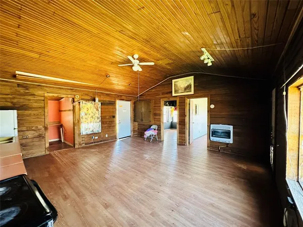 a view of a water heater room with wooden floor