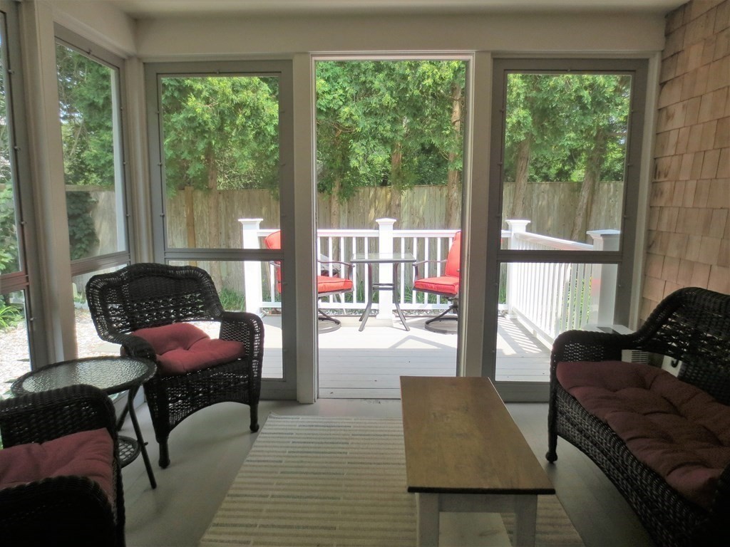558 Craigville Beach Road Barnstable, MA 02632 - Photo 11 of 35 a living room with furniture and a floor to ceiling window
