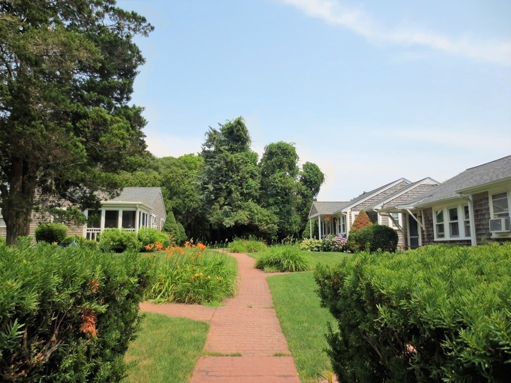 558 Craigville Beach Road Barnstable, MA 02632 - Photo 3 of 35 a front view of a house with a yard and potted plants