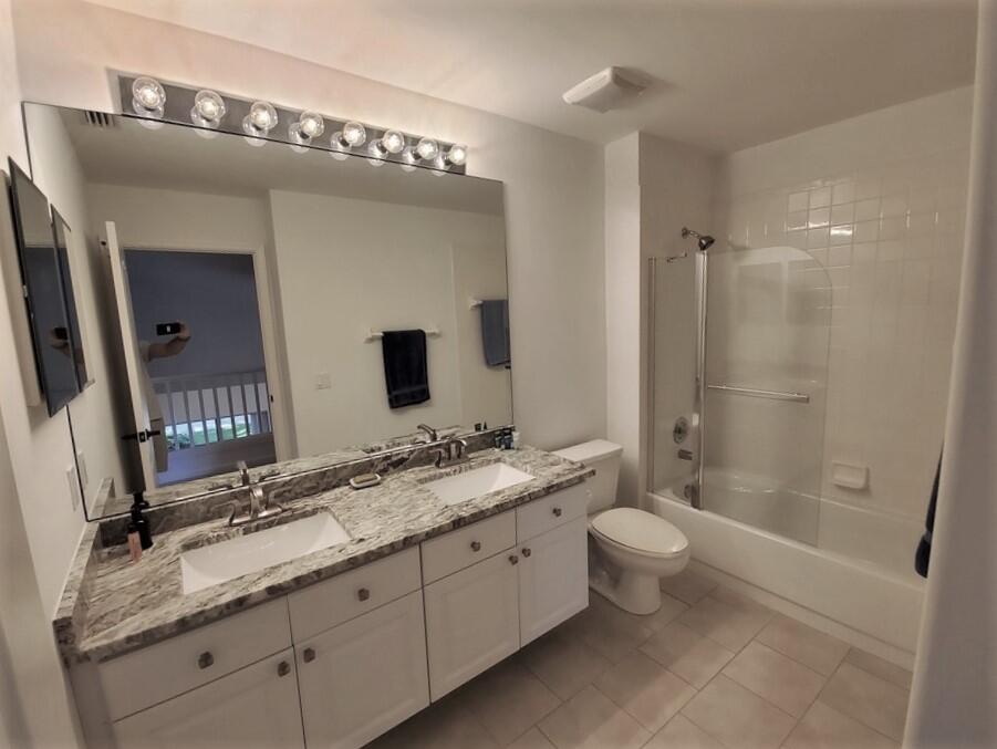 46 Pinnacle Cove Palm Beach Gardens, FL 33418 - Photo 18 of 20 a spacious bathroom with a double vanity sink toilet mirror and shower