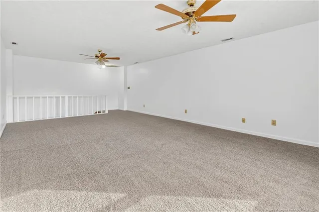 a view of a room with a ceiling fan