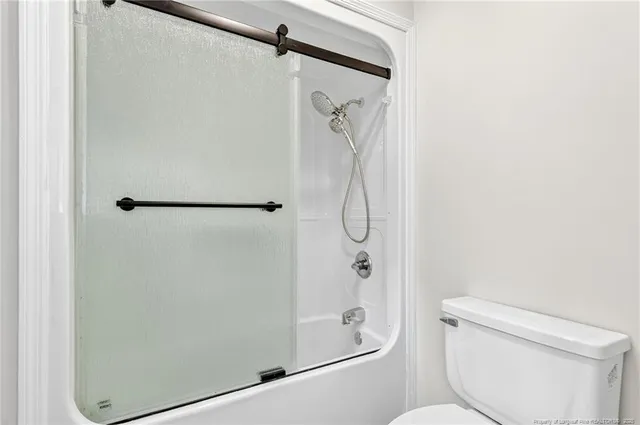 a bathroom with a shower toilet and sink