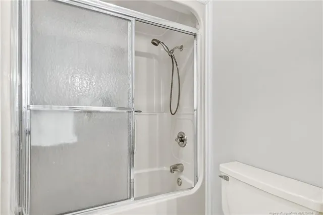 a bathroom with a shower and a toilet