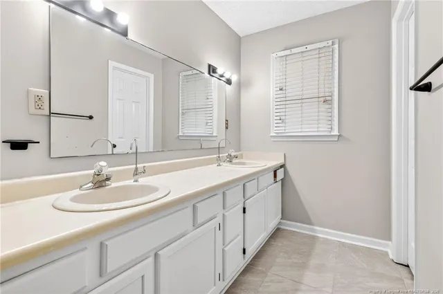 a bathroom with a double vanity sink a and a mirror