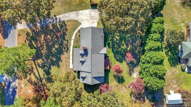 an aerial view of a house with a yard and garden