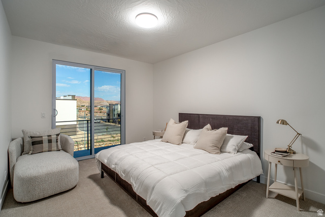 2768 Becco Trail, Unit 63 St. George, UT 84770 - Photo 11 of 27 Carpeted bedroom featuring access to outside and a textured ceiling