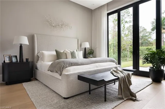 a bedroom with a bed and a potted plant