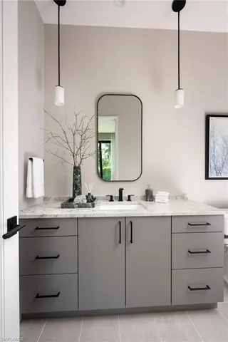 a bathroom with a double vanity sink and a mirror
